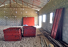 Metal windows and doors are stored inside the church